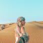 man and woman holding hands while in desert