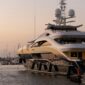 A white and gold yacht at anchor