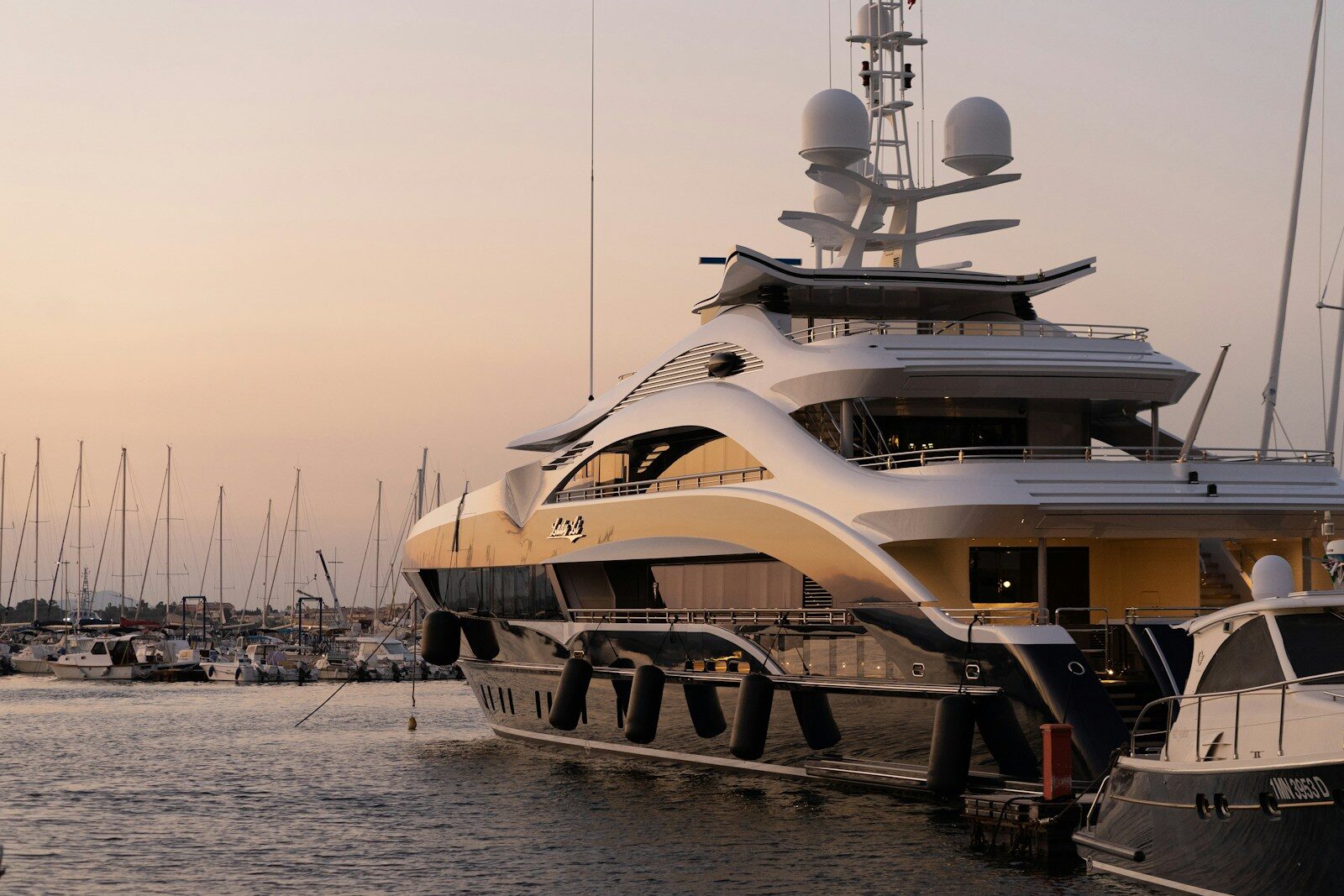 A white and gold yacht at anchor