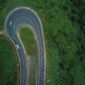 three vehicles on curved road