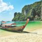 a boat sitting on top of a sandy beach