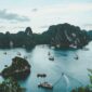 high-angle photography of boats on water near hill during daytime