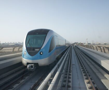 Blue and silver Dubai Metro train on the elevated track