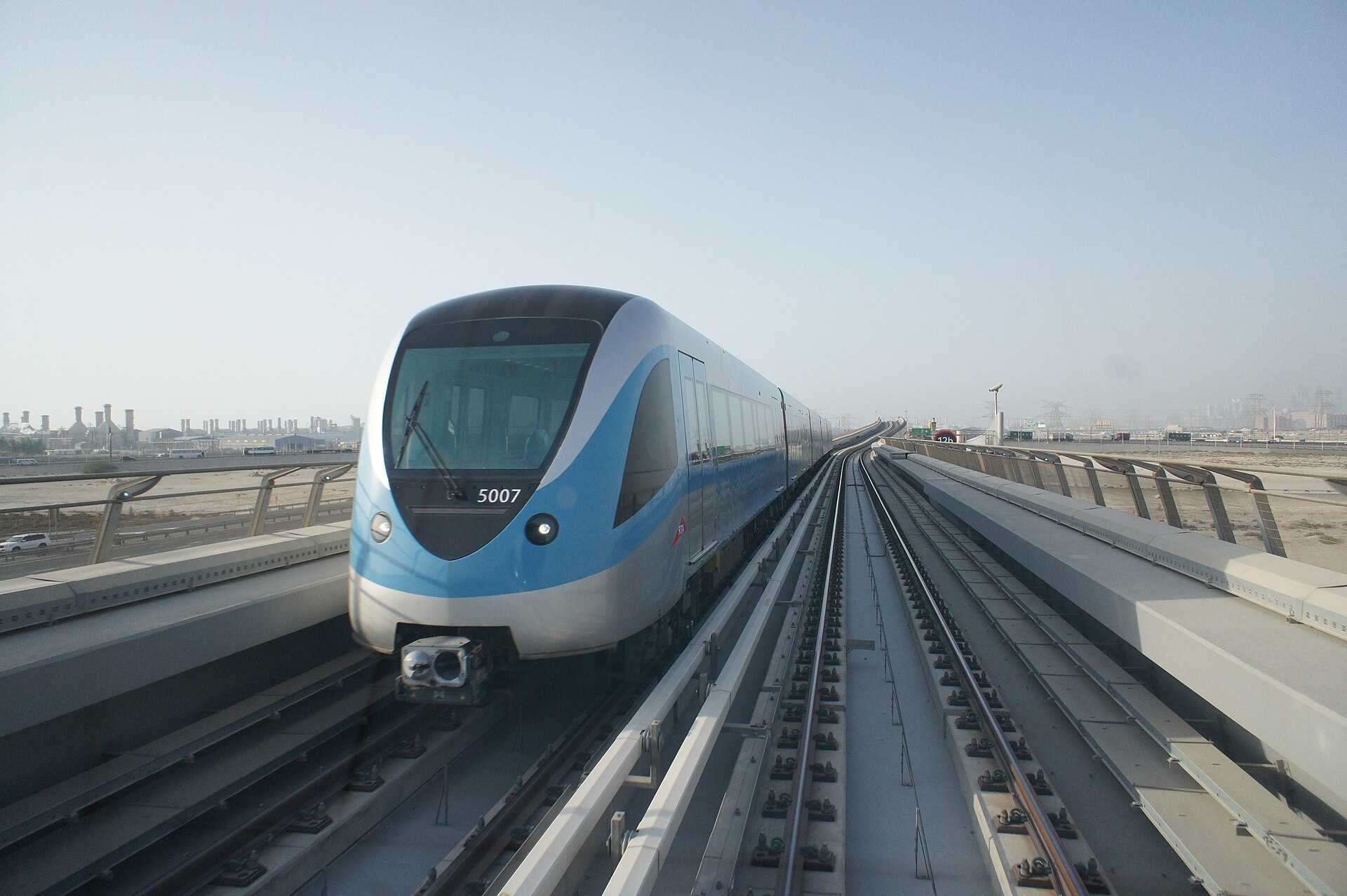 Blue and silver Dubai Metro train on the elevated track