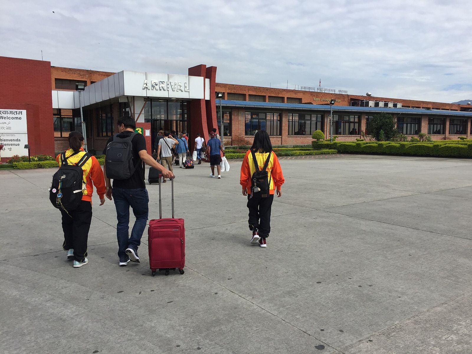 Travellers with luggage walking to the Arrival hall at Tribhuvan International Airport, Kathmandu